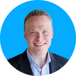Smiling professional man in a suit against a bright blue circular background