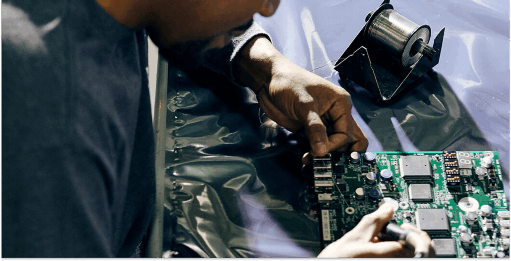 Technician soldering components on a printed circuit board